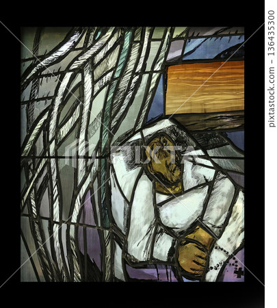 Simon of Cyrene carries the cross,  detail of stained glass window by Sieger Koder in Chapel in the Jesuit cemetery in Pullach, Germany 136435300