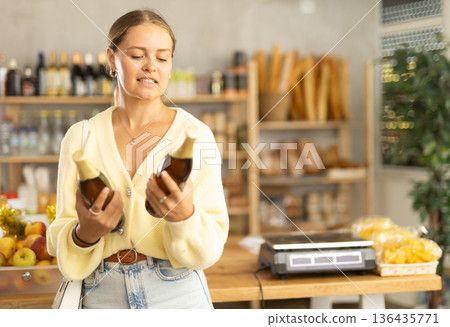 Female customer chooses beer 136435771