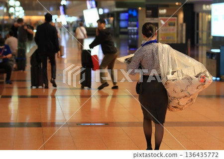 Airport staff cleaning up after the departure of the last flight 136435772