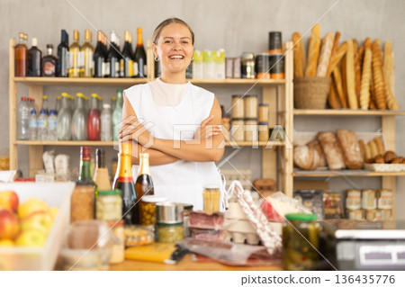 Smiling girl store clerk is preparing to meet customers Smiling girl store clerk is preparing to meet customers 136435776