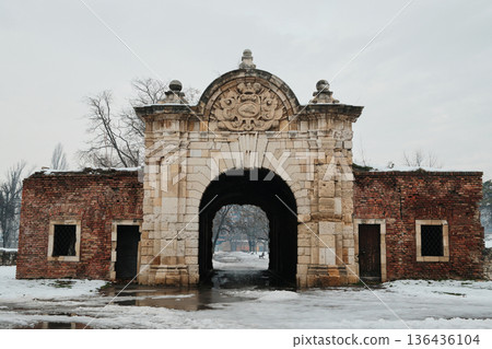 Historic stone gate of Kalemegdan Fortress covered with snow in Belgrade Serbia. Monumental military architecture and cultural heritage winter concept 136436104