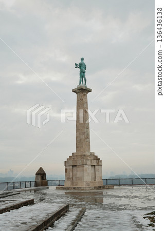 Victory Monument in Kalemegdan Fortress, Belgrade, standing tall against cloudy winter sky, emphasizing scale, history and symbolic city landmark Victory Monument in Kalemegdan Fortress, Belgrade, standing tall against cloudy winter sky, emphasizing scale, history and symbolic city landmark 136436138