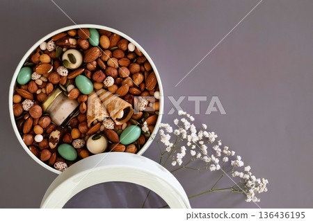 Peanuts in box. Gift to Women's Day (8 March), Women's Day. Mother's Day Valentines day. Festive round box. Peanuts in box. Gift to Women's Day (8 March), Women's Day. Mother's Day Valentines day. Festive round box. 136436195