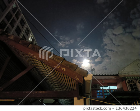Night sky cloud moonlight urban rooftop house building cloud antenna cable window night Night sky cloud moonlight urban rooftop house building cloud antenna cable window night 136436224