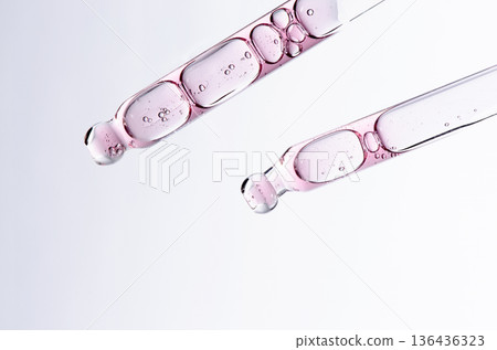 Skin serum in a pipette. A cosmetic product for body care. White background. Copy space 136436323