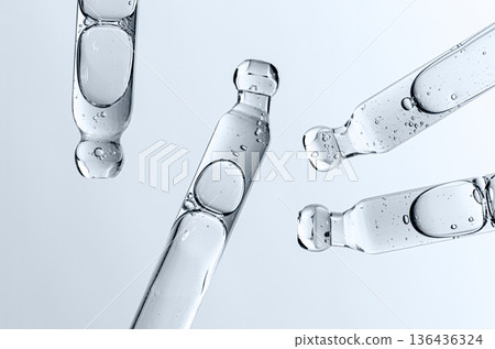 Skin serum in a pipette. A cosmetic product for body care. White background. Skin serum in a pipette. A cosmetic product for body care. White background. 136436324