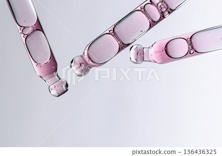 Skin serum in a pipette. A cosmetic product for body care. White background. Copy space Skin serum in a pipette. A cosmetic product for body care. White background. Copy space 136436325