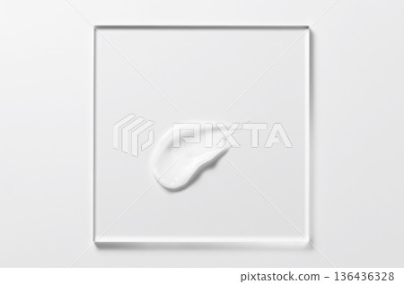 White cosmetic skin care product on glass. White background. 136436328
