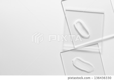 White cosmetic skin care product on glass. White background. Copy space White cosmetic skin care product on glass. White background. Copy space 136436330