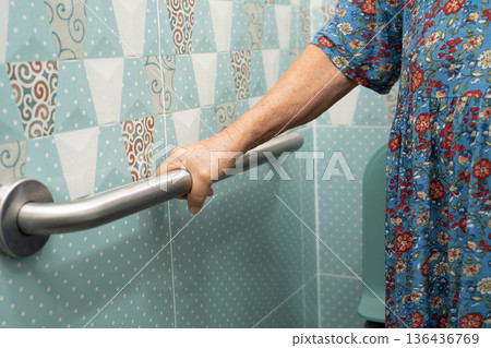 Asian elderly woman patient use toilet bathroom handle security in nursing hospital, healthy strong medical. Asian elderly woman patient use toilet bathroom handle security in nursing hospital, healthy strong medical. 136436769