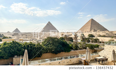 Luxurious terrace seating overlooking the three pyramids and the Sphinx: Cairo's tourist and resort image 136437432
