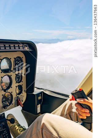 Passenger riding in a helicopter above clouds. Luxury travel experience and scenic tour over Cape Town, South Africa. Adventure vacation concept. Passenger riding in a helicopter above clouds. Luxury travel experience and scenic tour over Cape Town, South Africa. Adventure vacation concept. 136437663