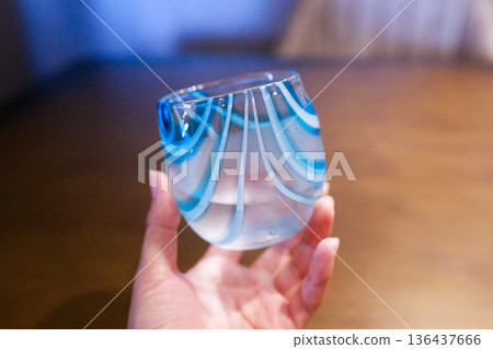 Image of holding Okinawan Ryukyu glass 136437666