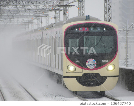 Keio 2000 series 2nd generation 2701F train kicking up snow as it runs Keio 2000 series 2nd generation 2701F train kicking up snow as it runs 136437740