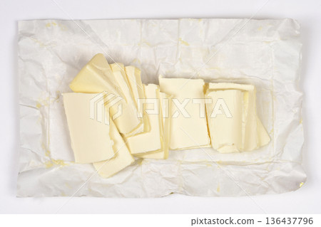 Sliced Yellow Margarine on White Paper Wrapper Sliced Yellow Margarine on White Paper Wrapper 136437796