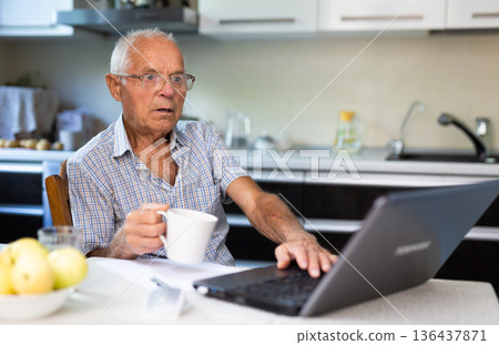Old man learning to use laptop at home Old man learning to use laptop at home 136437871