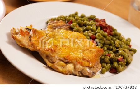 Fried boneless skinless chicken leg with green peas for garnish on plate Fried boneless skinless chicken leg with green peas for garnish on plate 136437928