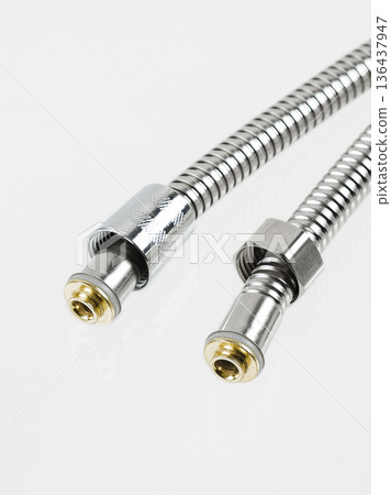 Flexible shower hose close-up. Metallic, chrome-plated, shiny. Flexible shower hose close-up. Metallic, chrome-plated, shiny. 136437947