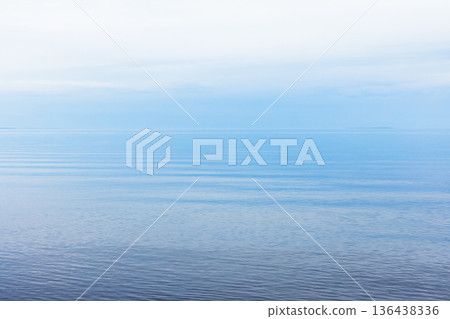 A tranquil seascape featuring a wide blue horizon A tranquil seascape featuring a wide blue horizon 136438336