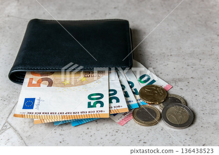 Black partmone with euro money. Coins and bills in leather wallet for commerce concept. Black partmone with euro money. Coins and bills in leather wallet for commerce concept. 136438523