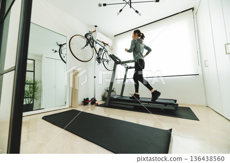 Woman running indoors 136438560