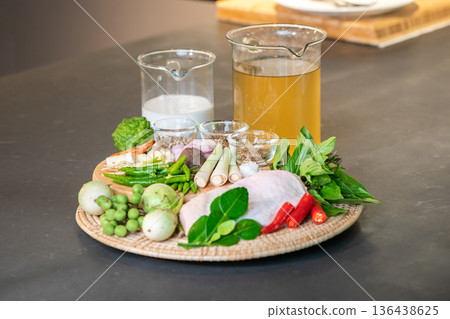 The ingredients, including chicken wings, chilli, kaffir lime leaves and lemongrass, are prepared to be cooked for a famous thai dish, Green Curry. The ingredients, including chicken wings, chilli, kaffir lime leaves and lemongrass, are prepared to be cooked for a famous thai dish, Green Curry. 136438625