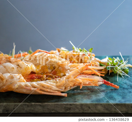 Close up to the Lobster Pad Thai is ready to serve with fried noodle, tofu and other ingredients on a rectangular plate in studio light. 136438629