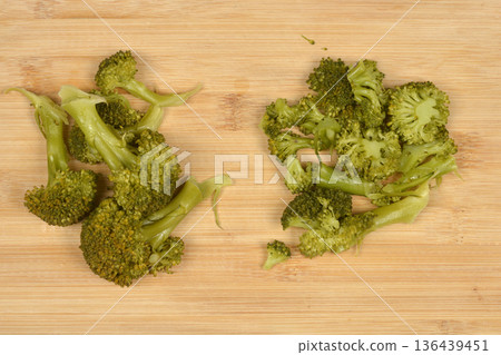 Cooked broccoli florets on wooden board 136439451