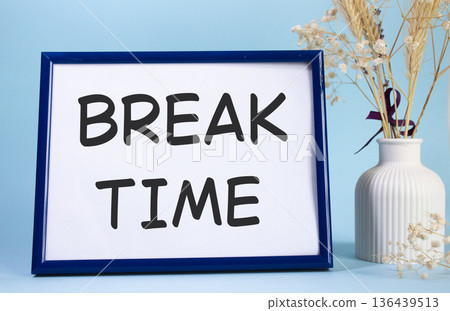 Break Time symbol. Concept words Break Time on beautiful wooden picture frame. Beautiful light blue background with flower vase. Business and Break Time concept. Copy space. Break Time symbol. Concept words Break Time on beautiful wooden picture frame. Beautiful light blue background with flower vase. Business and Break Time concept. Copy space. 136439513