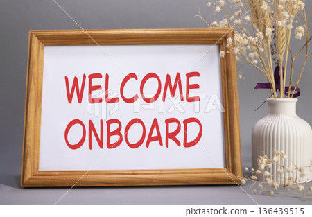 Welcome onboard symbol. Concept words Welcome onboard on beautiful wooden picture frame. Beautiful grey background with flower vase. Business and Welcome onboard concept. Copy space. Welcome onboard symbol. Concept words Welcome onboard on beautiful wooden picture frame. Beautiful grey background with flower vase. Business and Welcome onboard concept. Copy space. 136439515