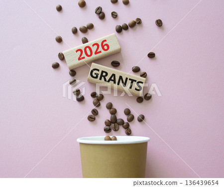 2026 Grants symbol. Concept words 2026 Grants on beautiful wooden picture frame. Beautiful pink background with coffee cup and coffee beans. Business and 2026 Grants concept. Copy space. 136439654