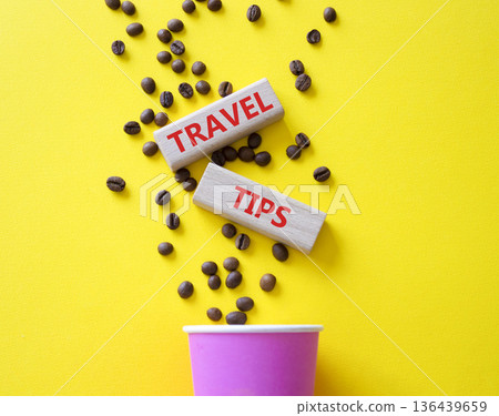 Travel tips symbol. Wooden blocks with words Travel tips. Beautiful yellow background with coffee cup and coffee beans. Business and Travel tips concept. Copy space. Travel tips symbol. Wooden blocks with words Travel tips. Beautiful yellow background with coffee cup and coffee beans. Business and Travel tips concept. Copy space. 136439659