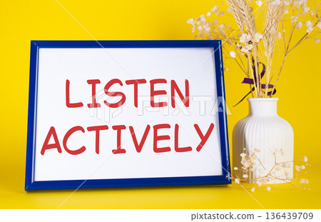 Listen actively symbol. Concept words Listen actively on beautiful wooden picture frame. Beautiful yellow background with flower vase. Business and Listen actively concept. Copy space. Listen actively symbol. Concept words Listen actively on beautiful wooden picture frame. Beautiful yellow background with flower vase. Business and Listen actively concept. Copy space. 136439709