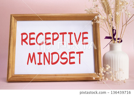 Receptive Mindset symbol. Concept words Receptive Mindset on beautiful wooden picture frame. Beautiful pink background with flower vase. Business and Receptive Mindset concept. Copy space. 136439716