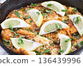 Haddock fish piccata with lemon and capers in cast iron pan, horizontal closeup 136439996