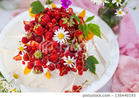 Delicious Pavlova meringue cake decorated with fresh summer berries 136440193