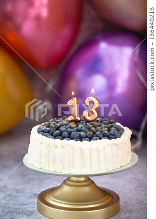 Blueberry birthday cake with number candels 13 for teenager celebration 136440216
