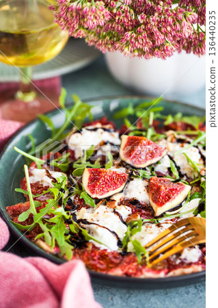 Delicious fresh fig carpaccio with burrata or stracciatella or mozzarella cheese and arugula salad 136440235