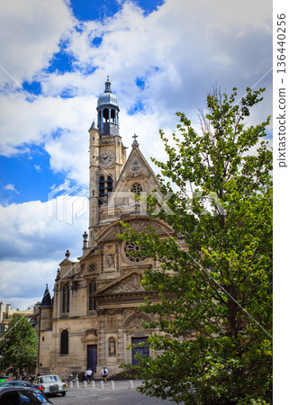 View of beautiful architecture and trees on summer streets in the city center of Paris, France View of beautiful architecture and trees on summer streets in the city center of Paris, France 136440256