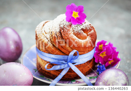 Sweet Easter bread, panettone or cruffin and colorful painted eggs, Holiday spring concept Sweet Easter bread, panettone or cruffin and colorful painted eggs, Holiday spring concept 136440263