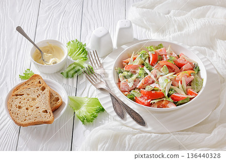 Tossed avocado and tomato salad with mayonnaise 136440328