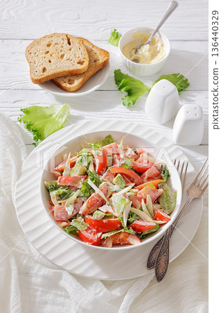 Tossed avocado and tomato salad with mayonnaise Tossed avocado and tomato salad with mayonnaise 136440329