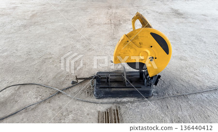 Electric metal cutter on concrete floor 136440412