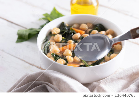 Chickpea and Spinach Soup with Carrots in White Bowl 136440763