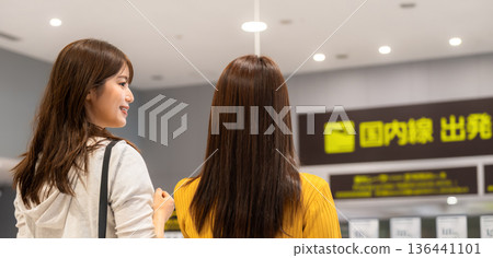 Two people looking at an information board at the airport ■Photography cooperation: Kansai International Airport (KIX) 136441101