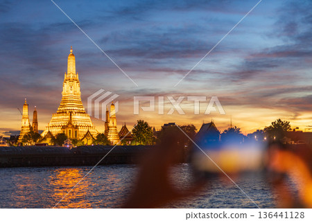 Tourists take photos with their smartphones at Wat Arun Ratchawararam Ratchaworamahawihan during sunset in Bangkok, Thailand. Tourists take photos with their smartphones at Wat Arun Ratchawararam Ratchaworamahawihan during sunset in Bangkok, Thailand. 136441128