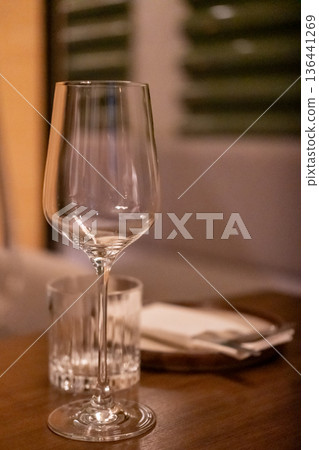 Empty wine glass on the table, with blur background in the restaurant 136441269