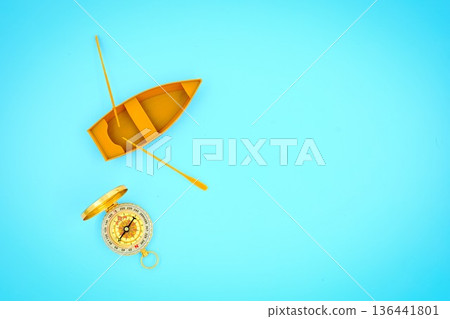 Open Golden Compass And Row Boat Light Blue Background Open Golden Compass And Row Boat Light Blue Background 136441801