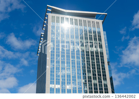 Glass building in metropolis. Skyscraper perspective view. City architecture. Architecture of modern glass building. Perspective city skyscraper. Modern skyscraper building. Modern city 136442002