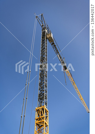 Construction site with building crane. Industrial area. Building and construction. Hoisting crane. Construction at building site with crane. Construction crane at building area Construction site with building crane. Industrial area. Building and construction. Hoisting crane. Construction at building site with crane. Construction crane at building area 136442017